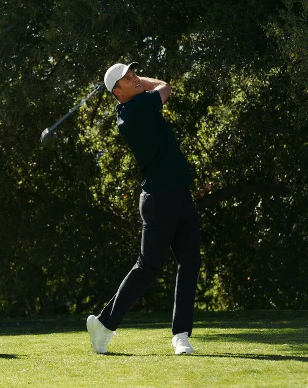 man playing golf wearing tom brady's new golf apparel