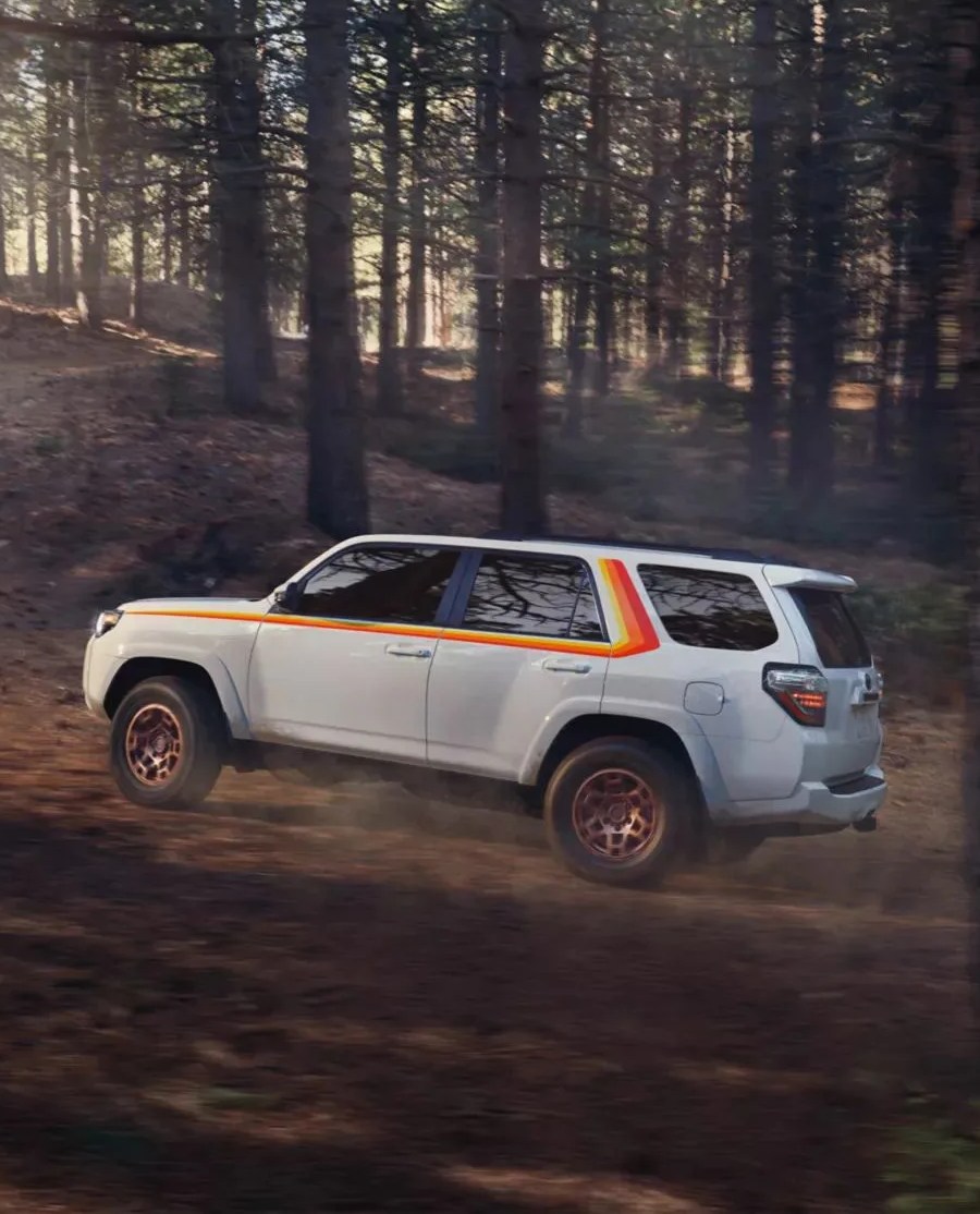 toyota 4runner driving through forest