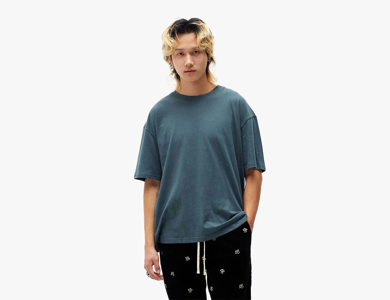 Man wearing PS Basics Loch Solid Boxy T-Shirt