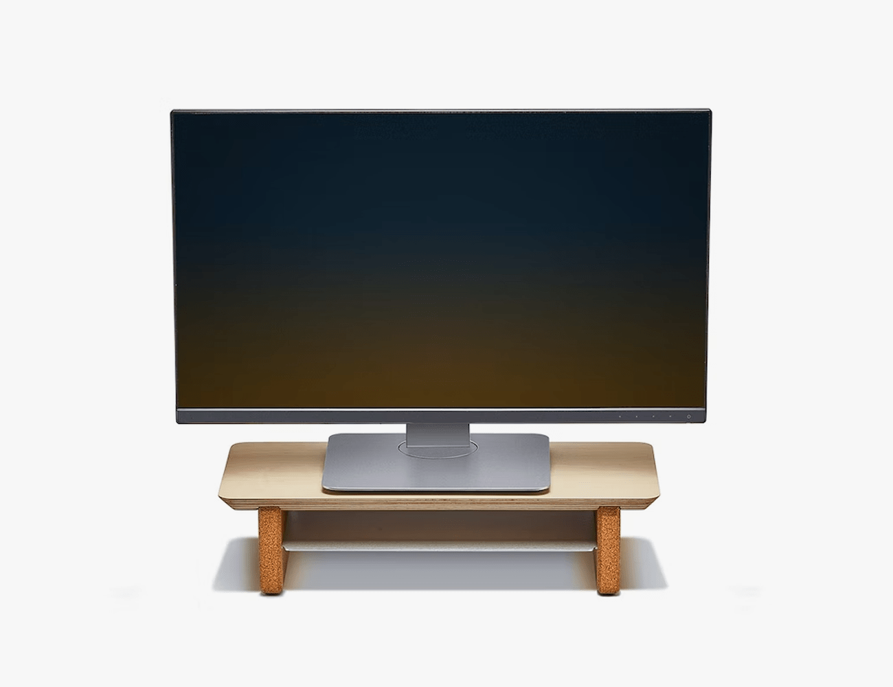 a Grovemade Desk Shelf in solid walnut with a computer screen sitting on it