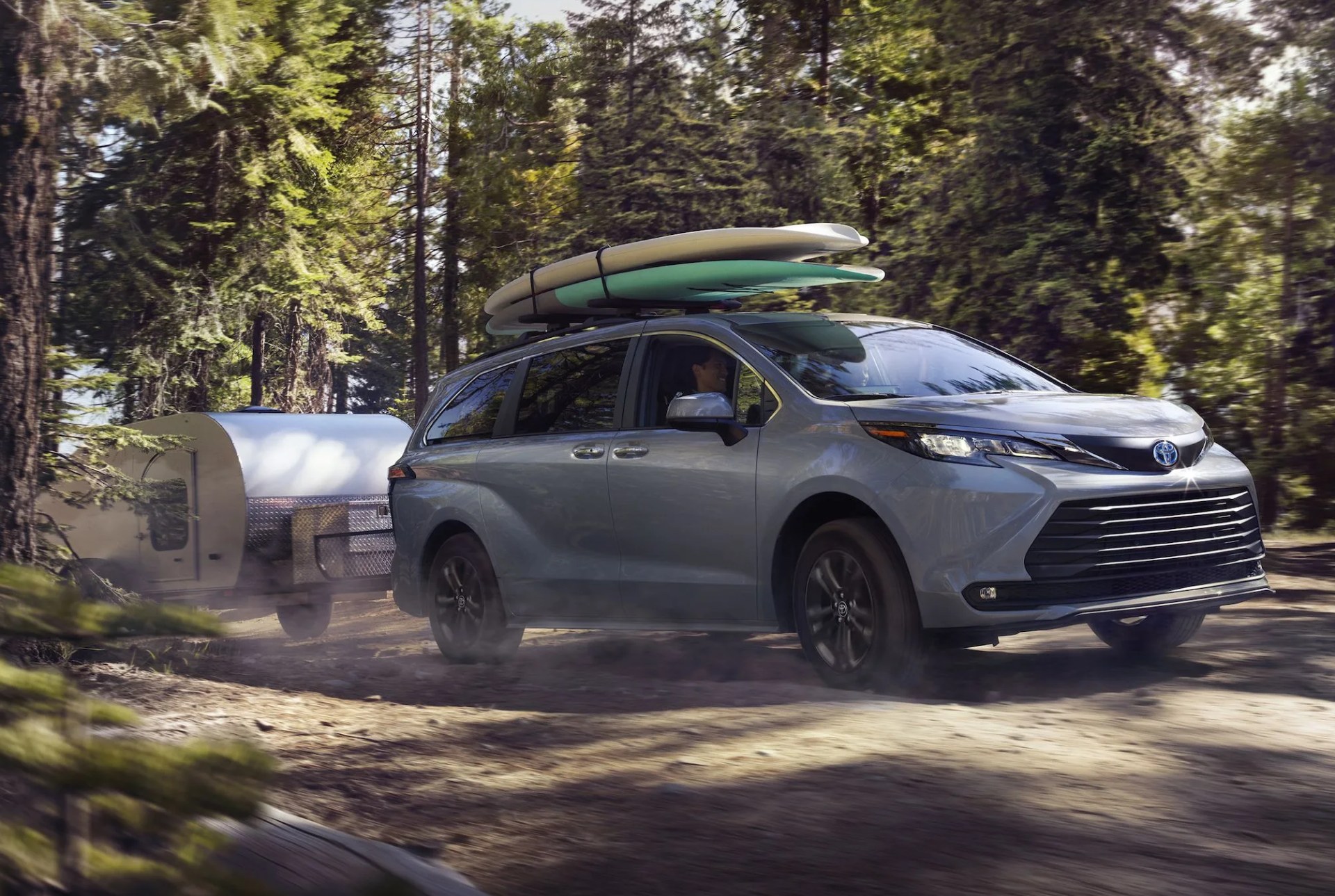 toyota sienna with surfboards and a trailer