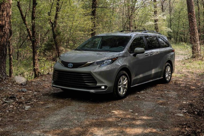 a car parked on a dirt road surrounded by trees