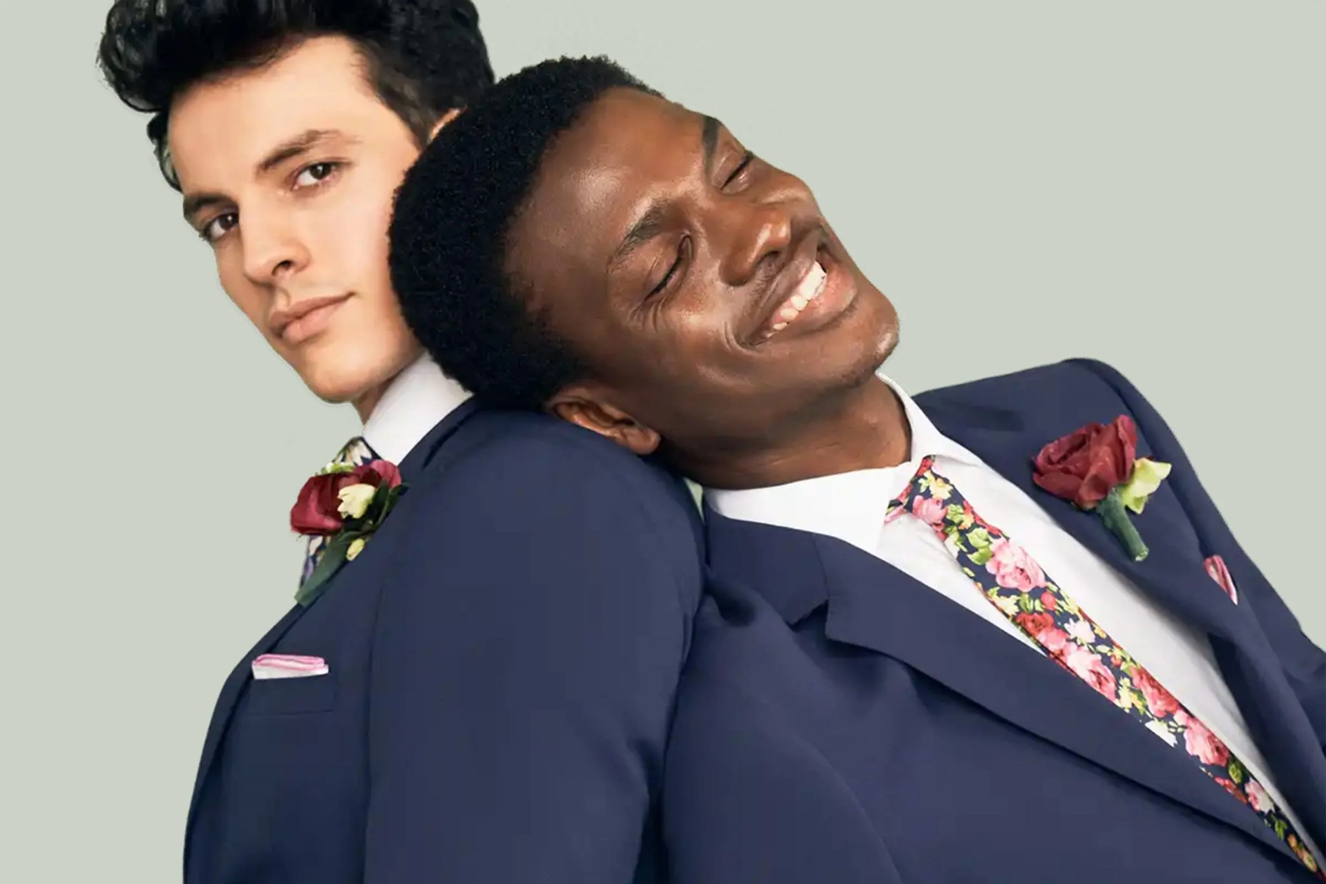 two men leaning on each other wearing suitshop tuxes