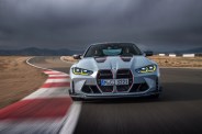 bmw m4 csl driving on track with storm clouds in the background