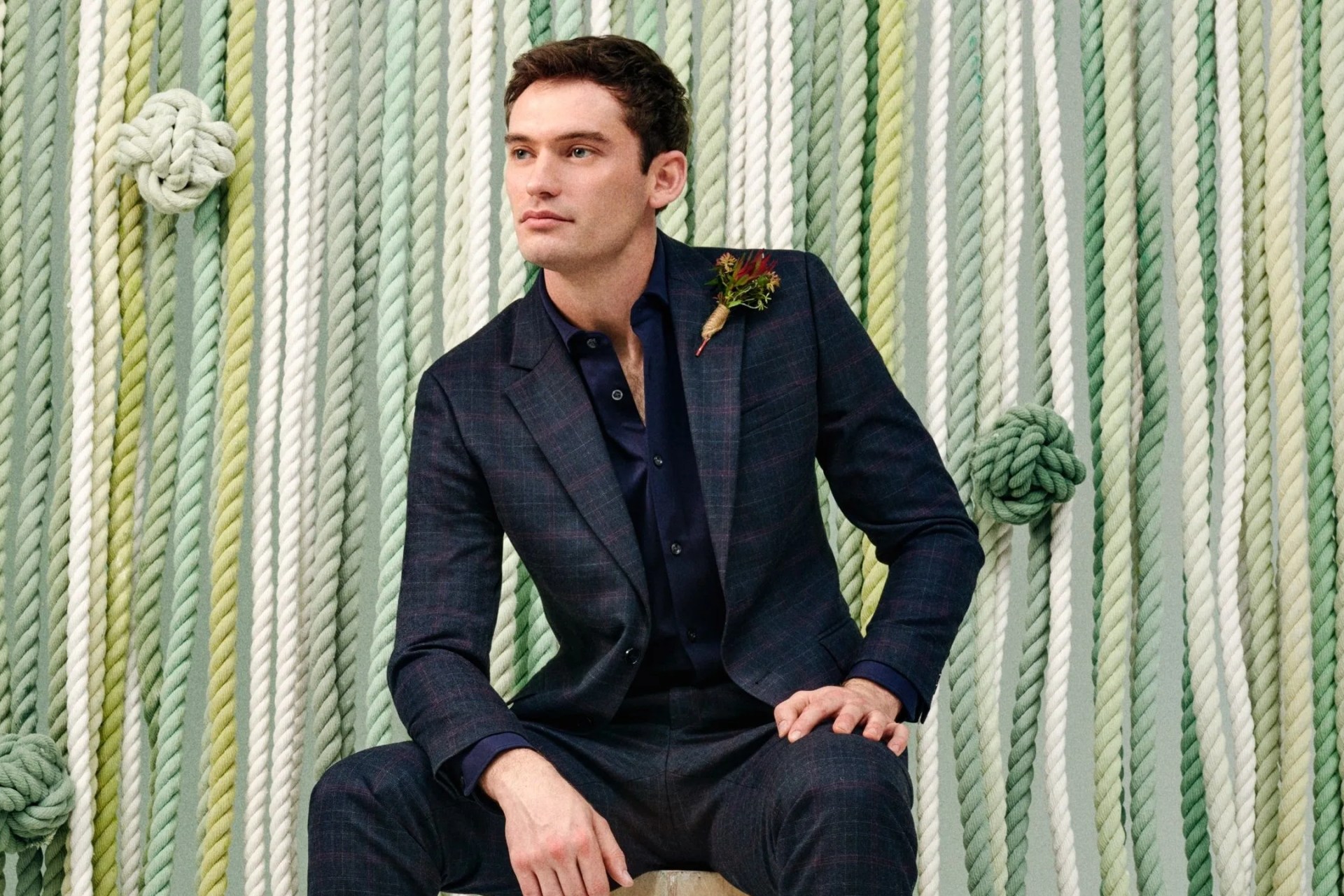 man wearing moss bros suit