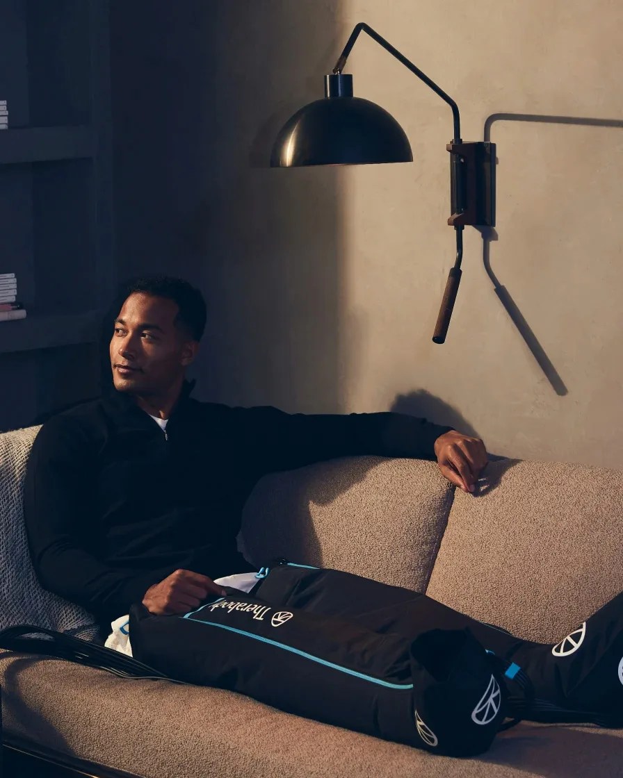 man sitting on couch with recovery boots