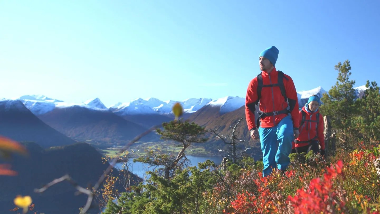 man hiking up hill wearing gore tex jacket