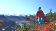 man hiking up hill wearing gore tex jacket
