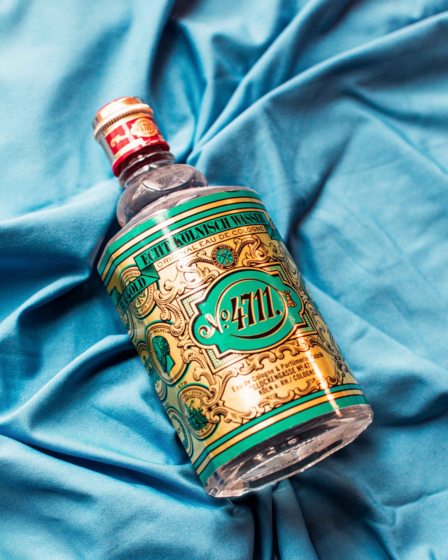 bottle of cologne on blue backdrop