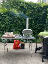 ooni karu pizza oven on table with condiments