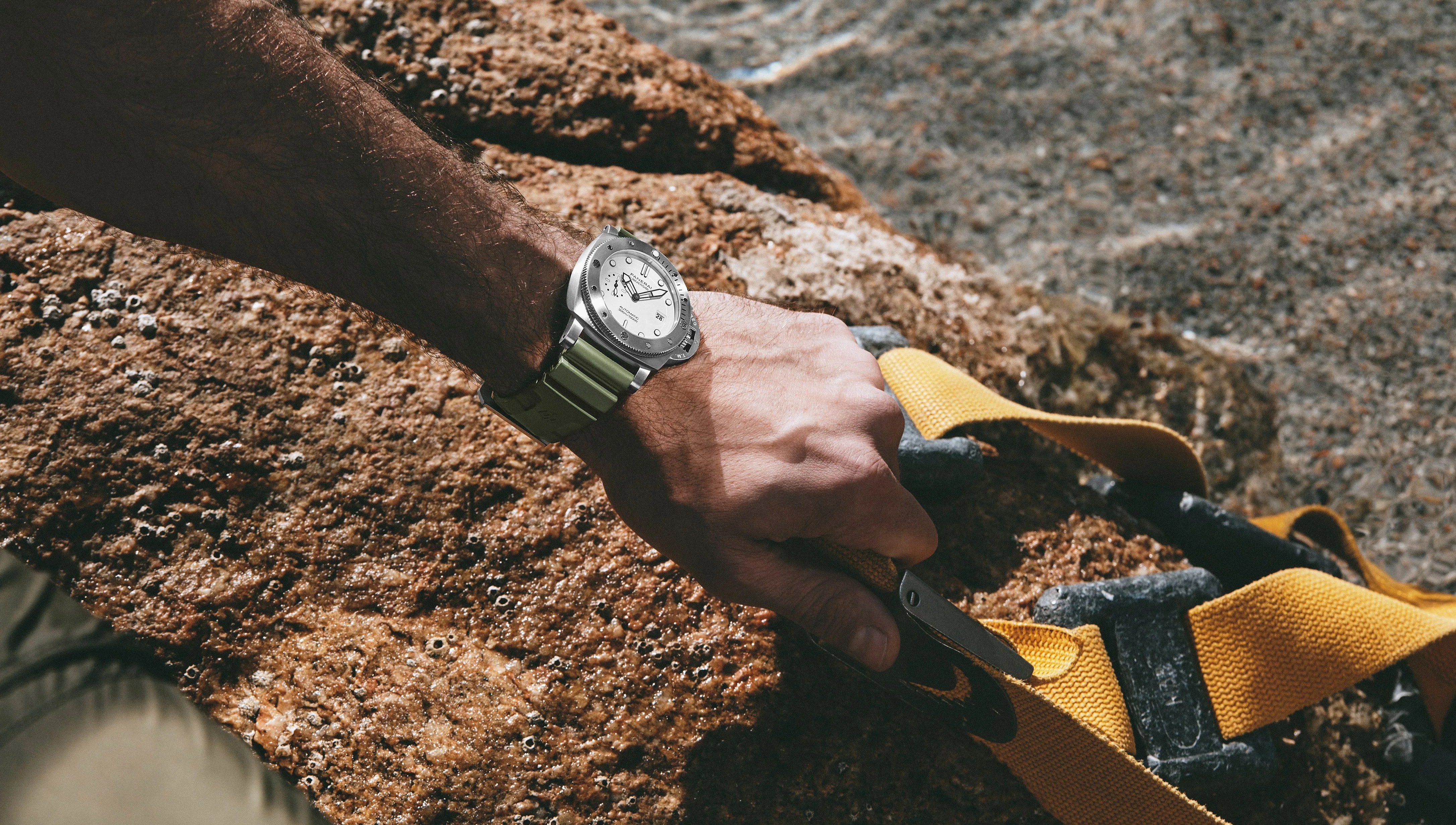 man crouching down wearing panerai watch