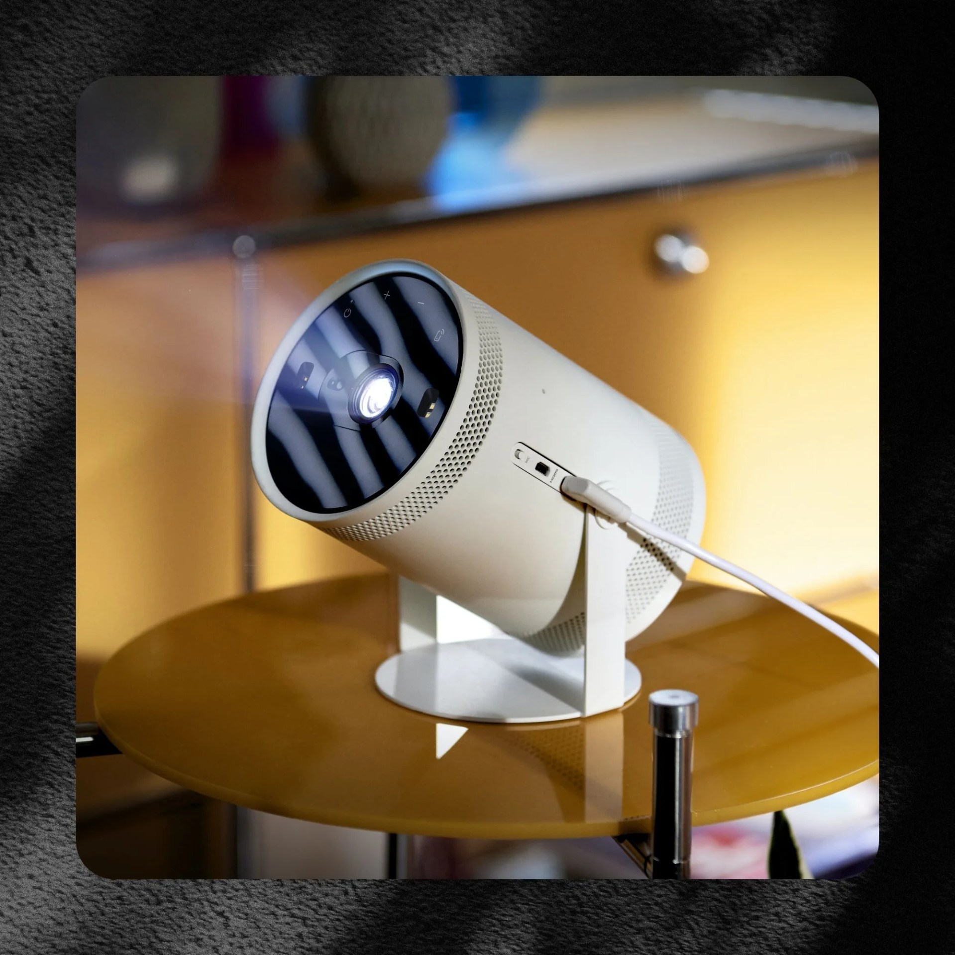 samsung projector pointed upward on a small round table