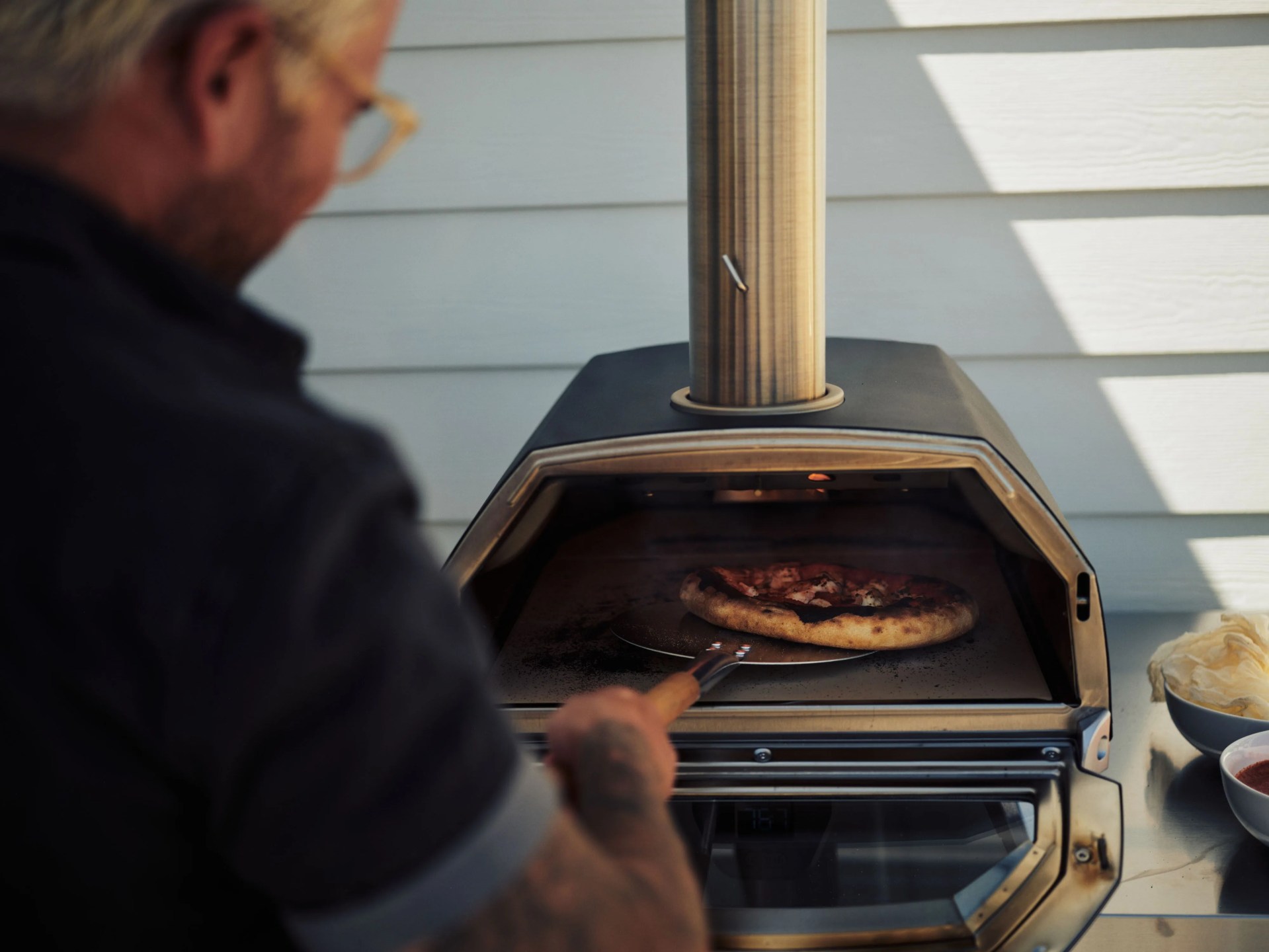marco checking pizza in ooni karu oven