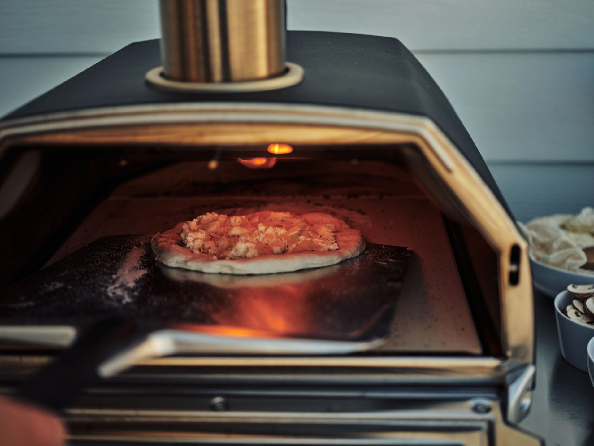 checking pizza in oven