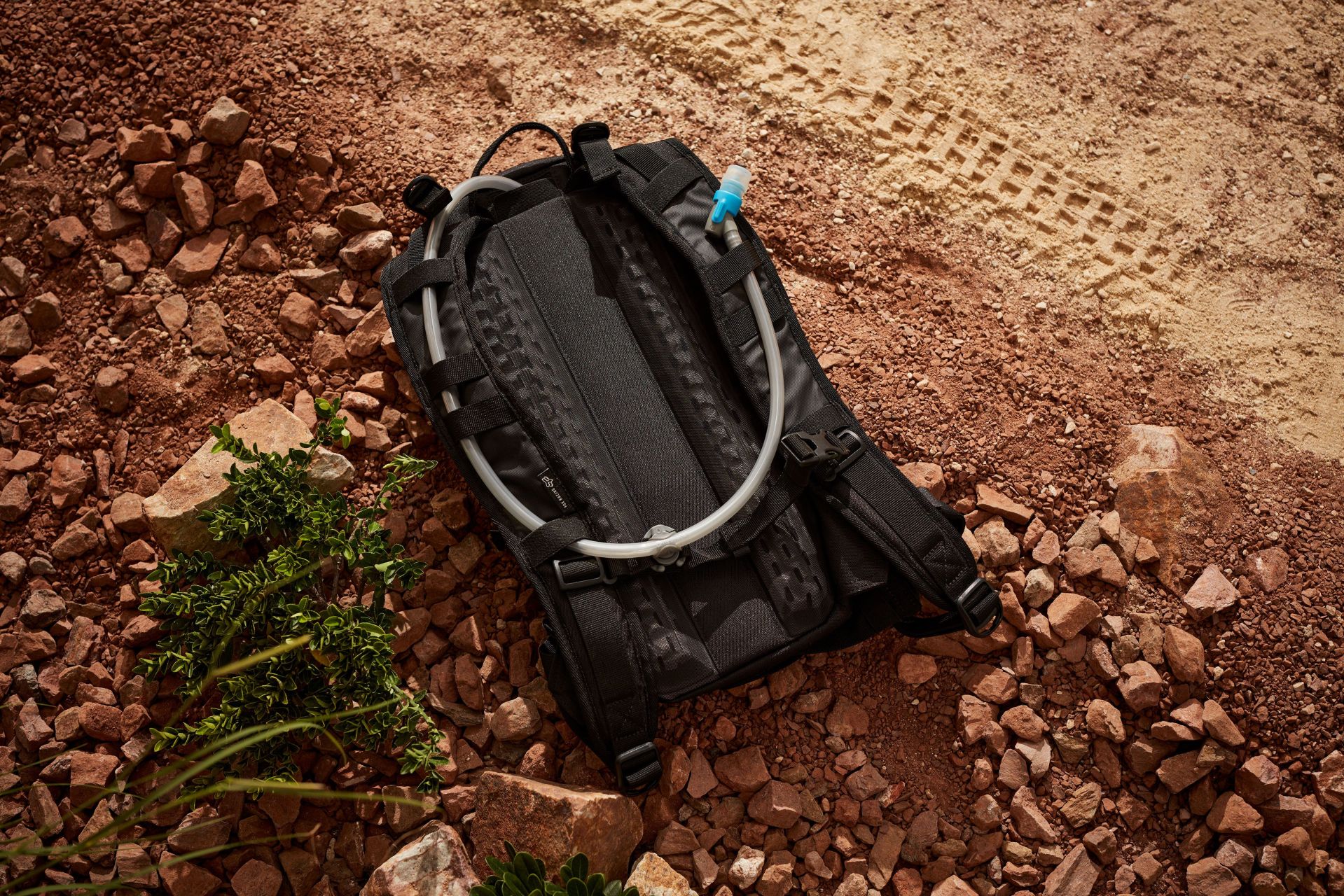 fox racing hydration pack back laying on rocks and dirt