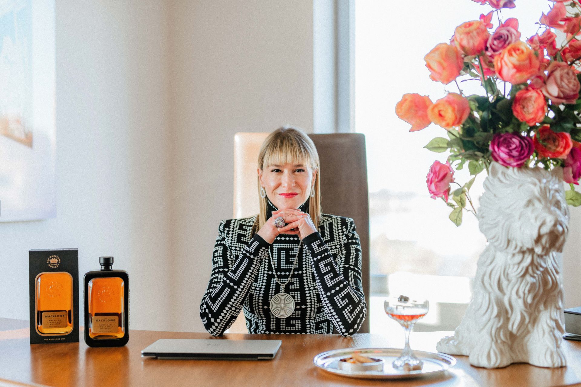founder julie macklowe sits at a desk with macklowe whiskey