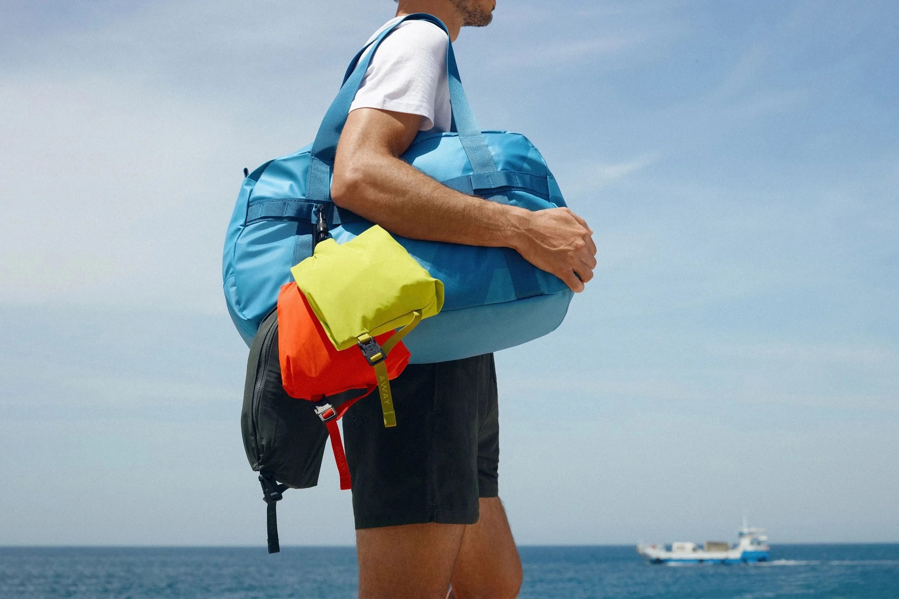 person holding away travel bags