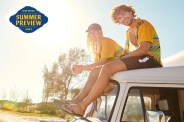 couple sitting on roof of a van