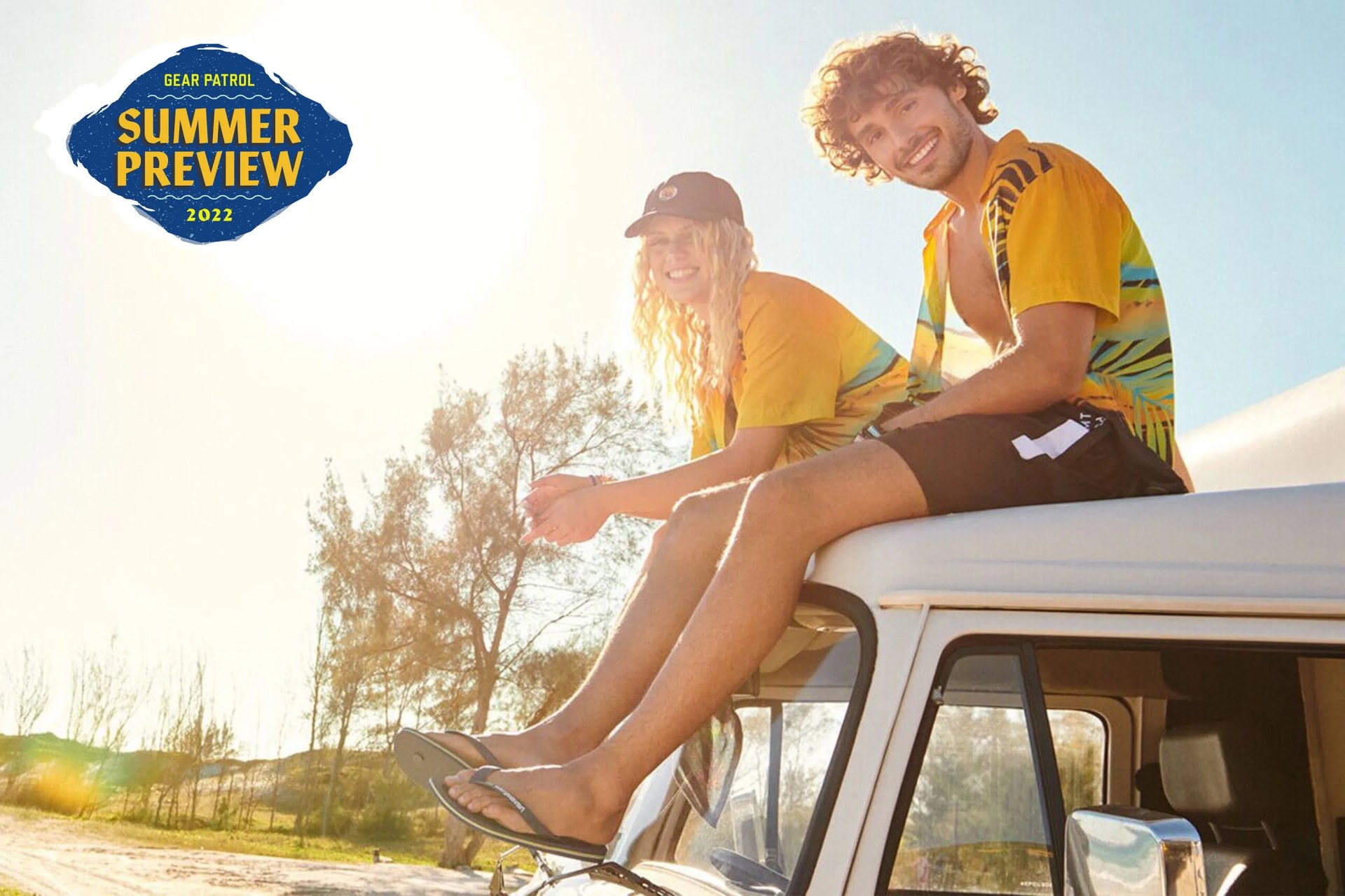 couple sitting on roof of a van