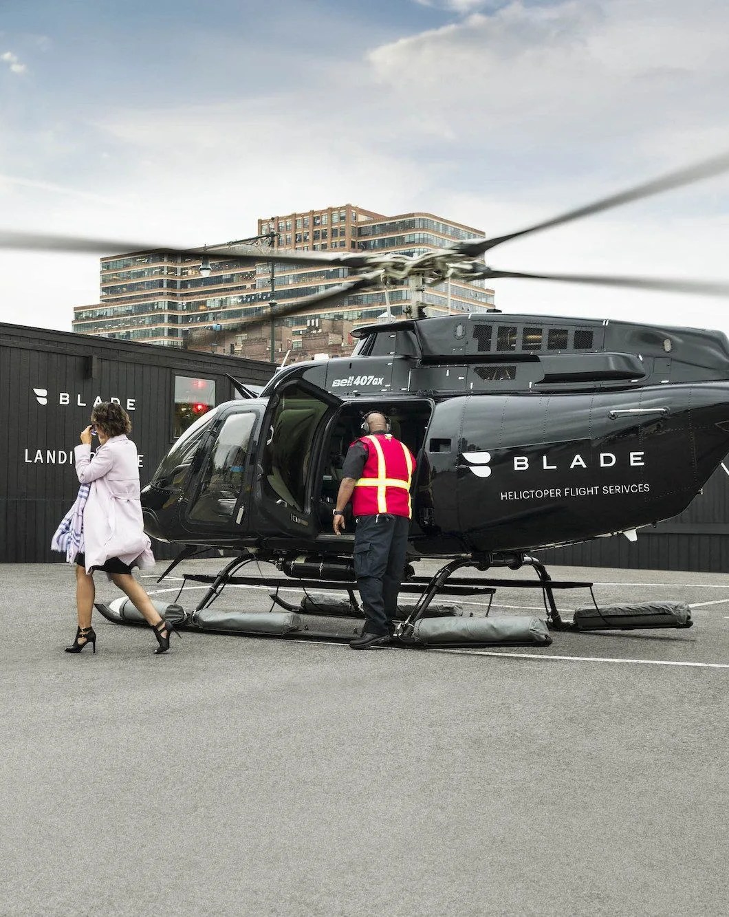 woman walking away from  blade air mobility helicopter