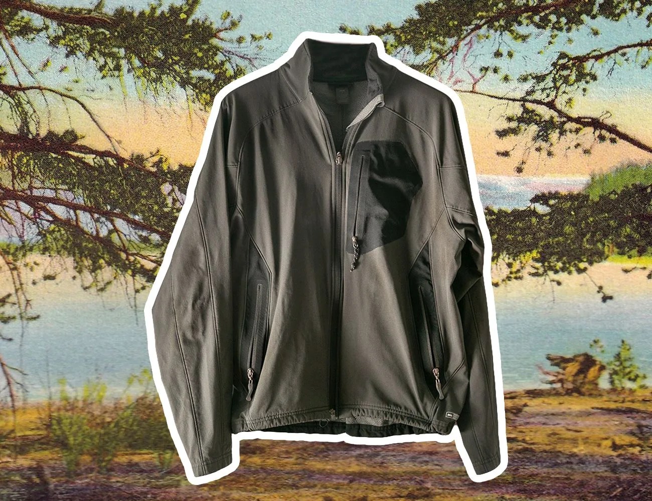 a grey rei jacket with front left chest pocket overlayed on a photo of a lake with trees and a mountain
