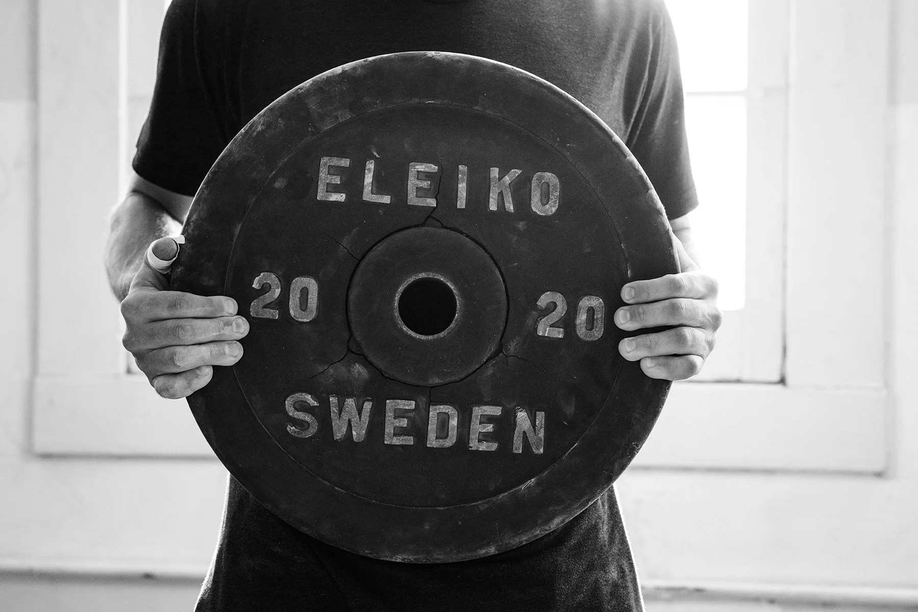 man holding eleiko weight