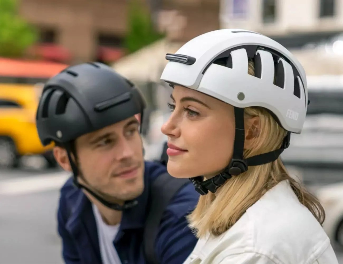 woman and man wearing bike helmets