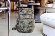 camo filson dryden backpack sitting on a floor