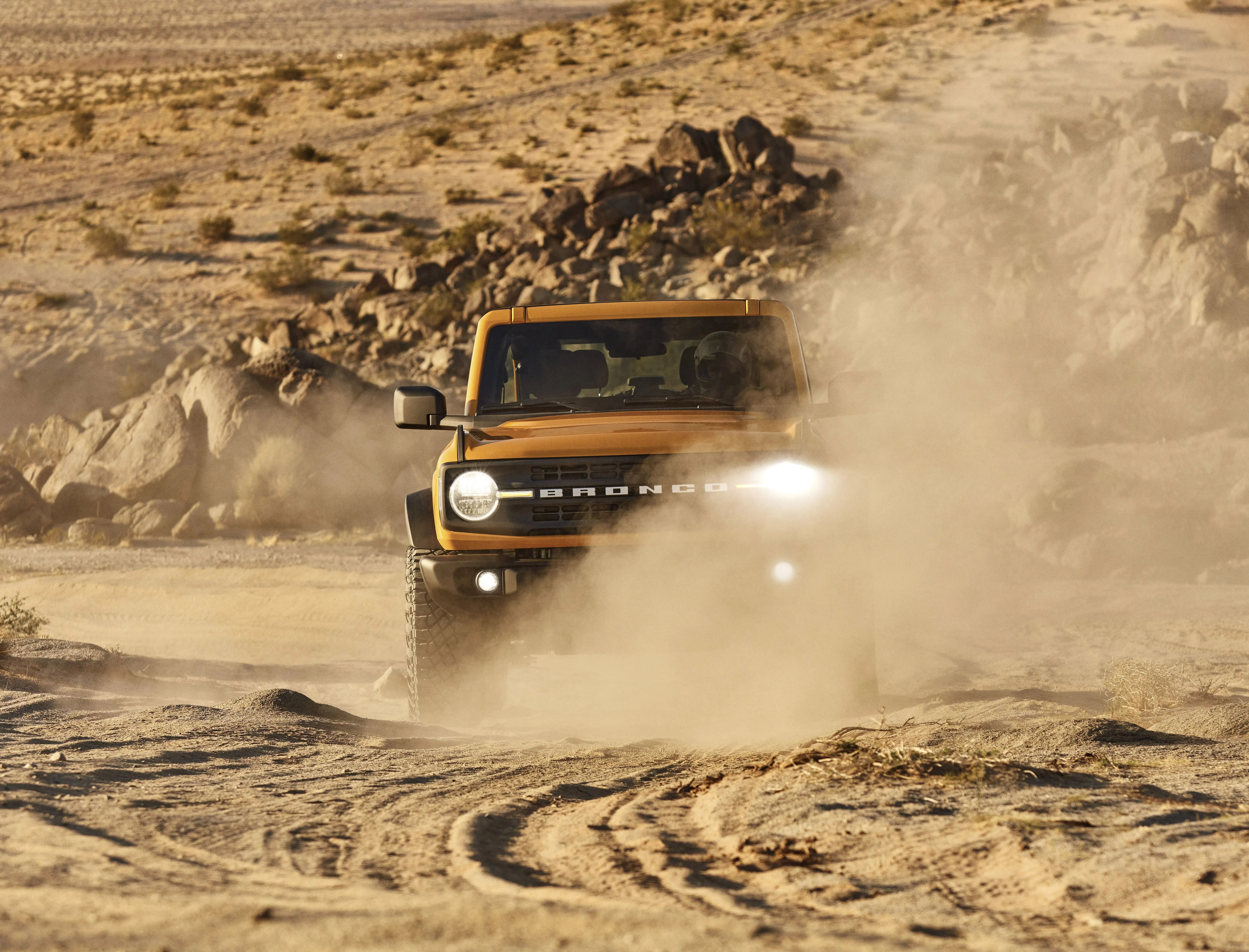 ford bronco driving through desert