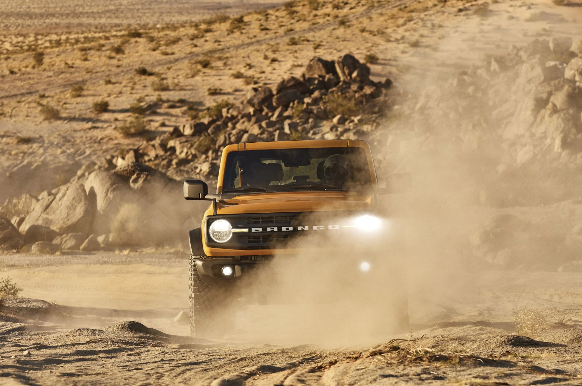 ford bronco driving through desert