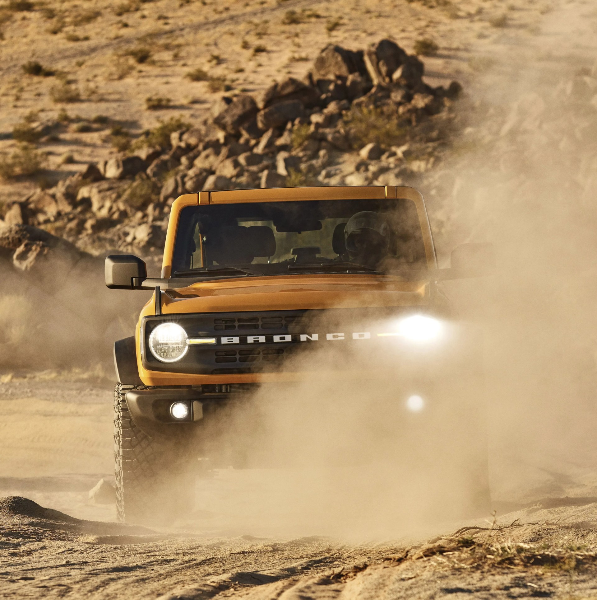 ford bronco driving through desert
