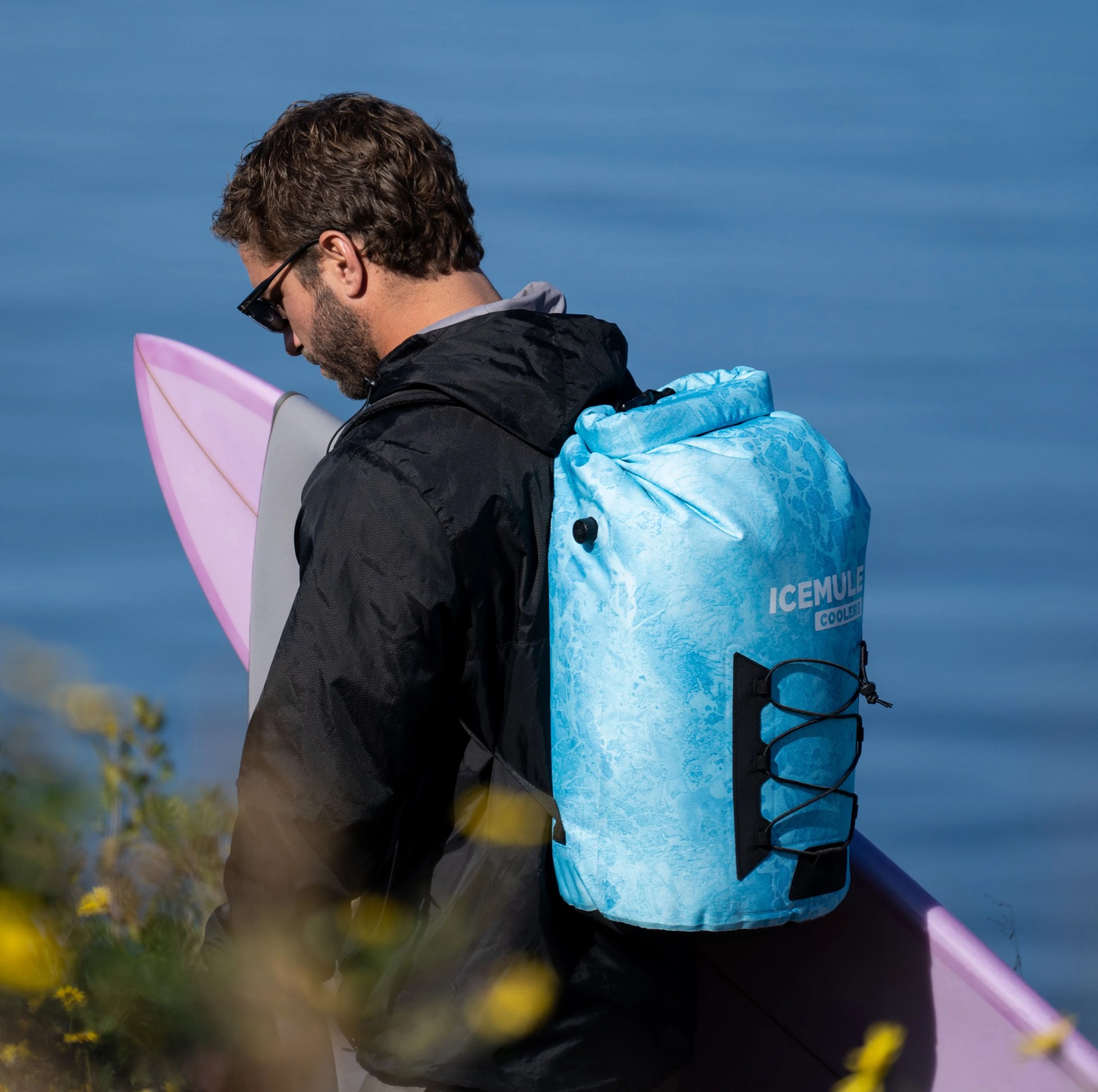man carrying icemule pro 23l realtree wave cooler on back