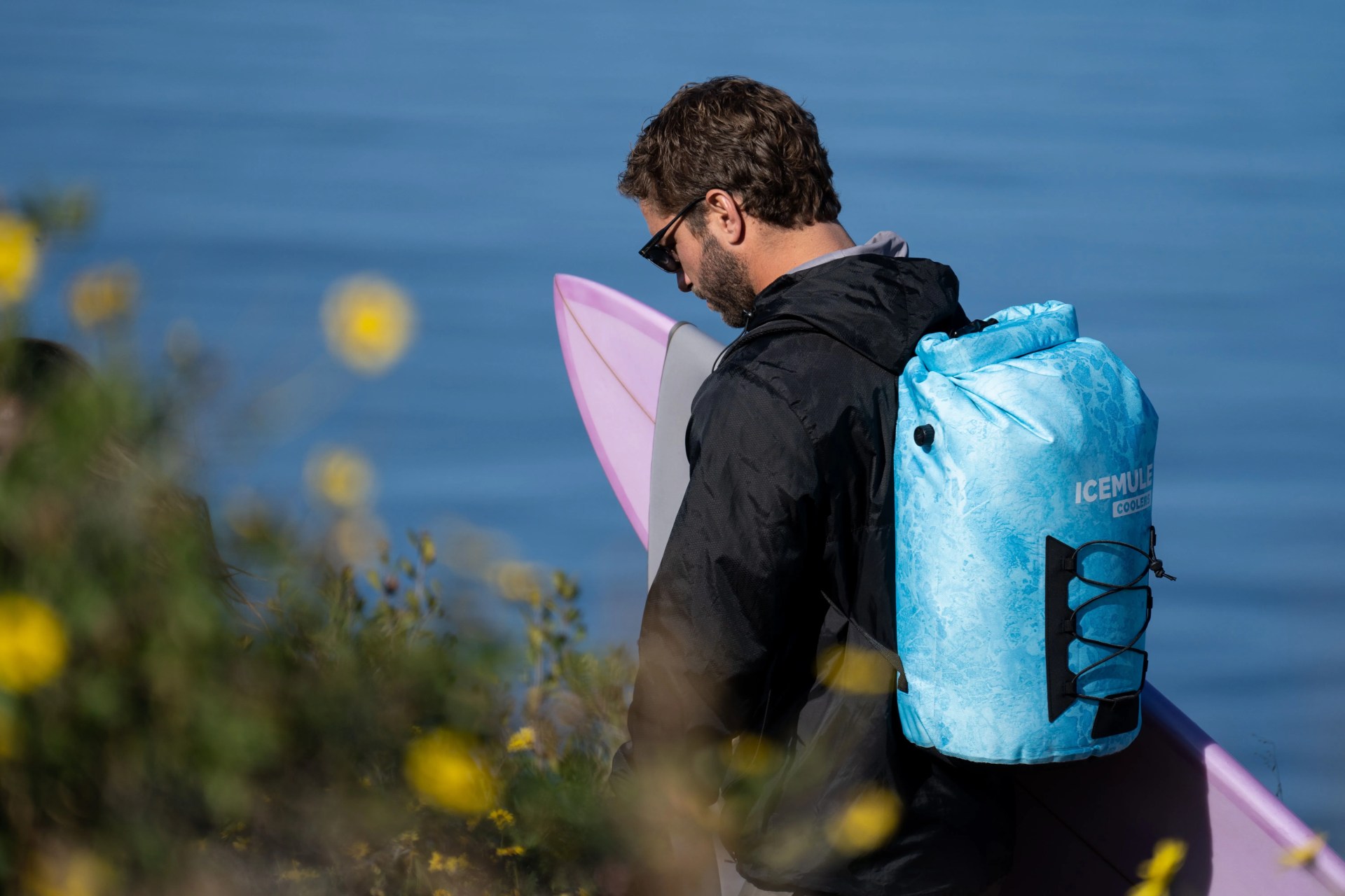 man carrying icemule pro 23l realtree wave cooler on back