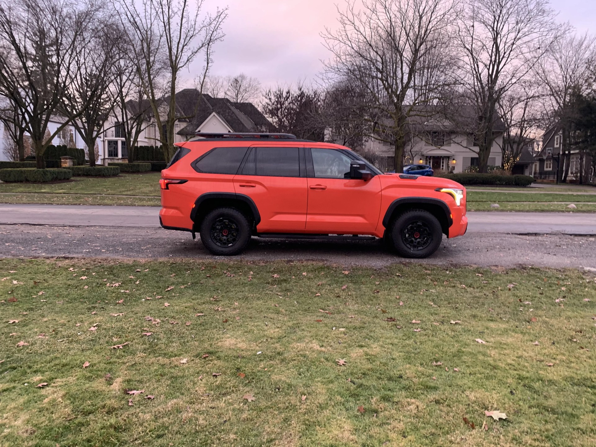 toyota sequoiad from the side parked in front of houses