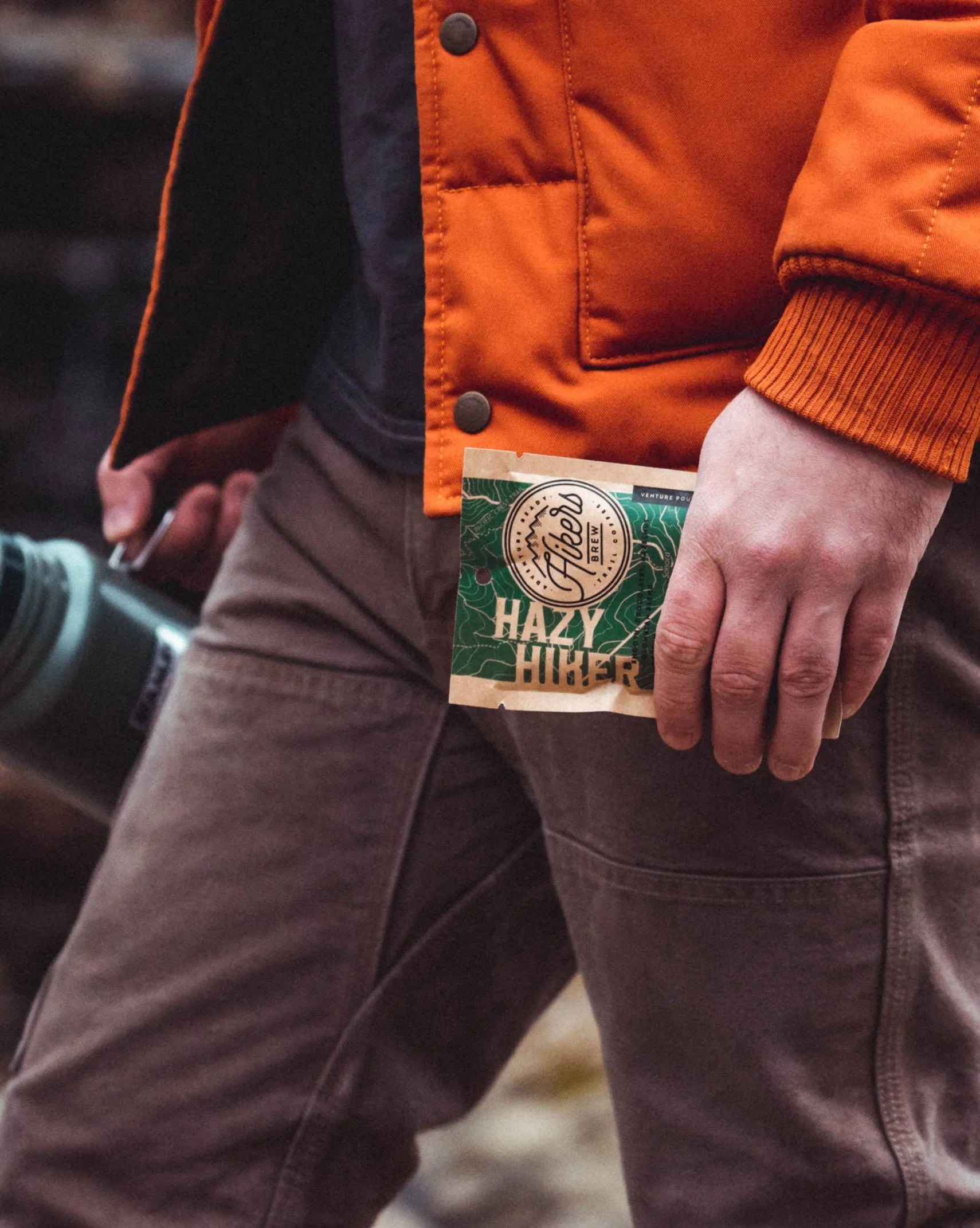 man holding hikers brew coffee hazy hiker