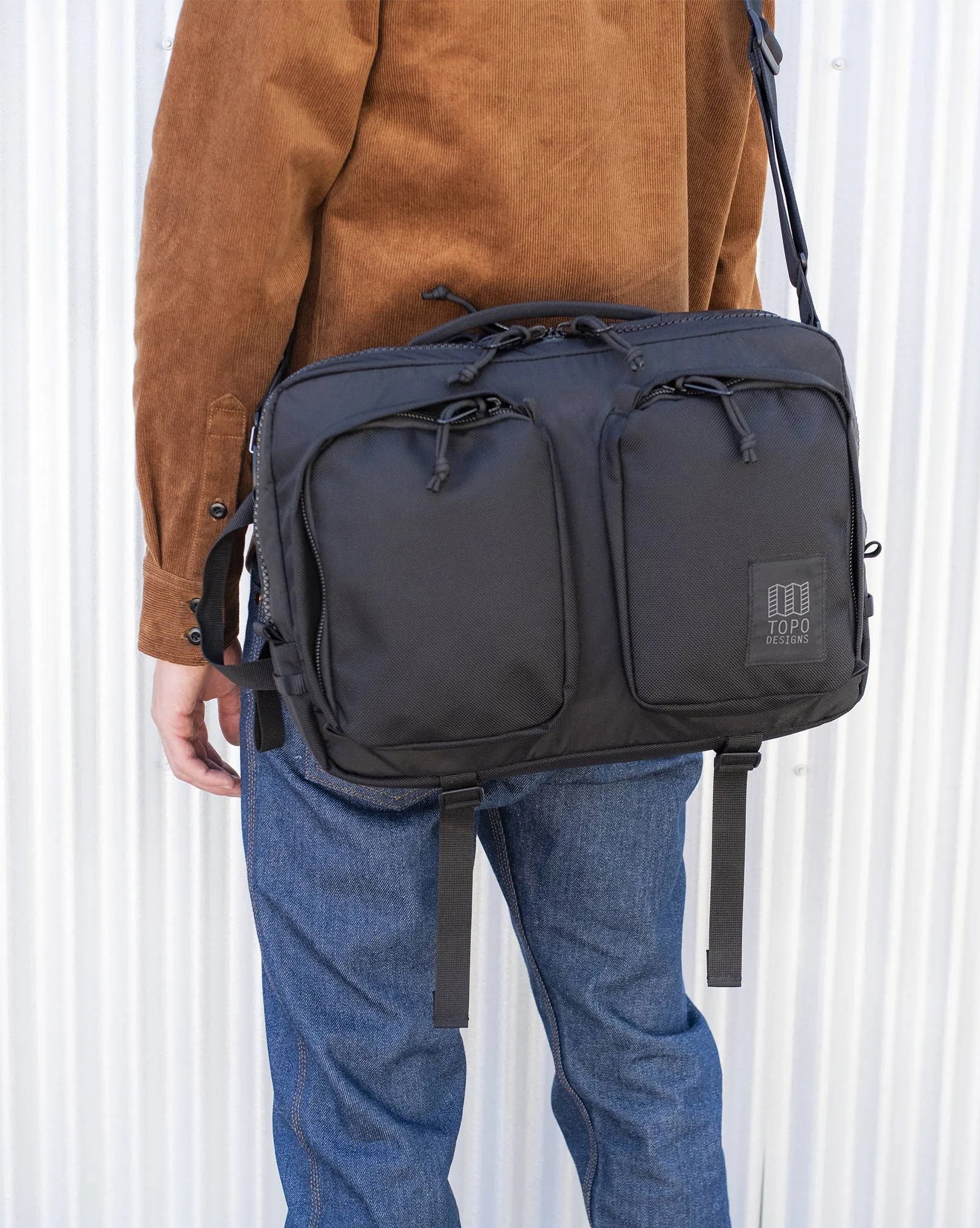 man wearing topo designs global briefcase