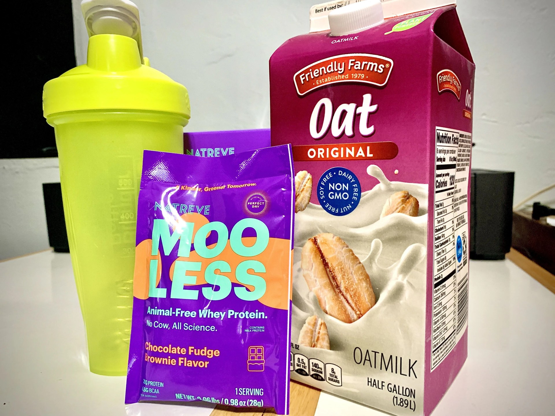 a mooless protein packet, oat milk, and shaker bottle