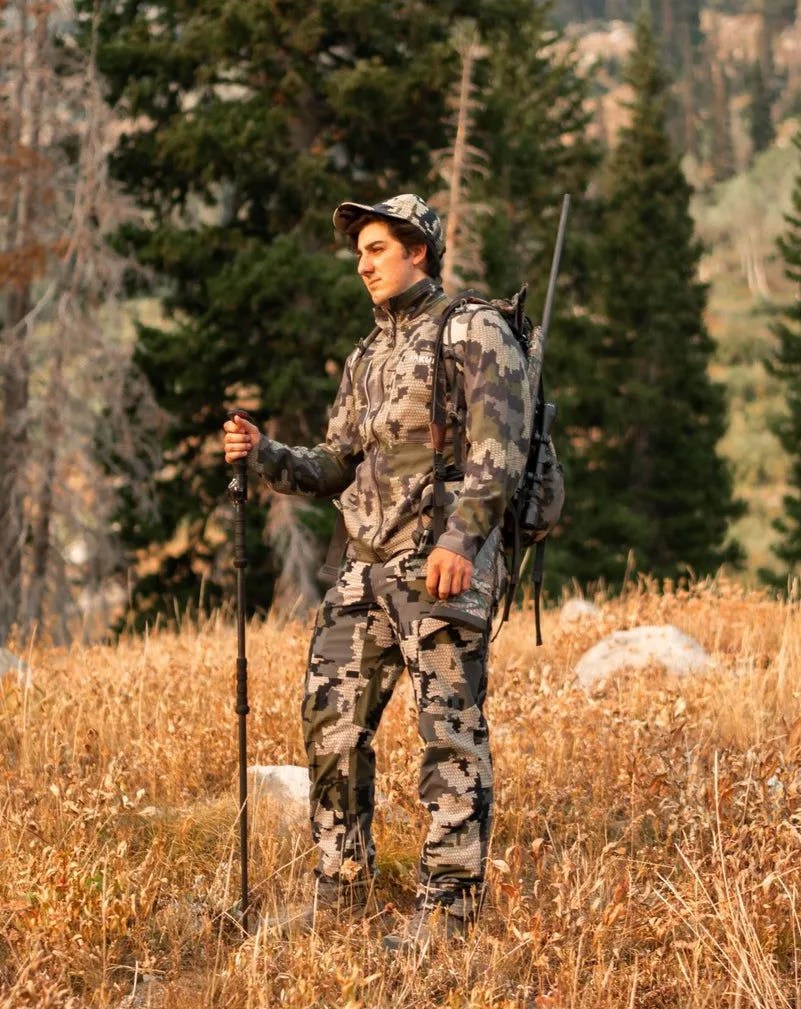 hunter standing in field holding col mountain tech mountain stick