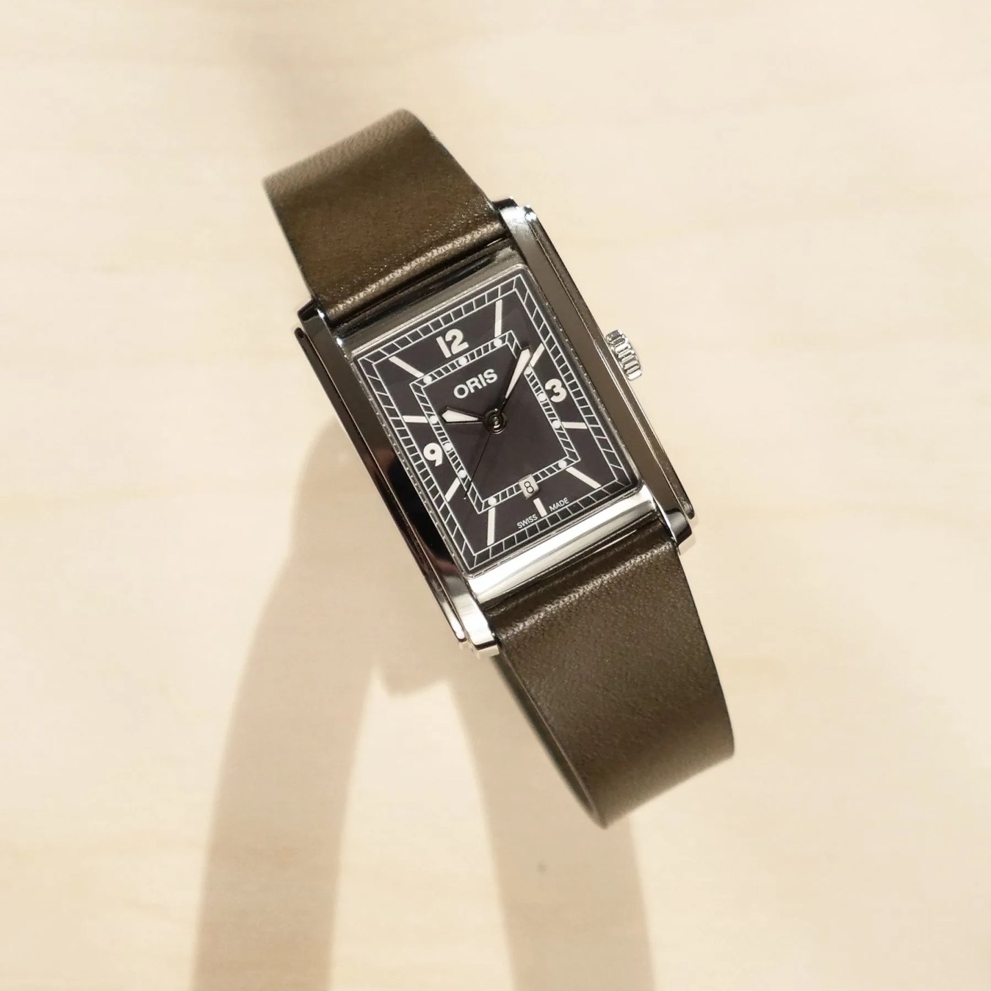 oris rectangular watch on table