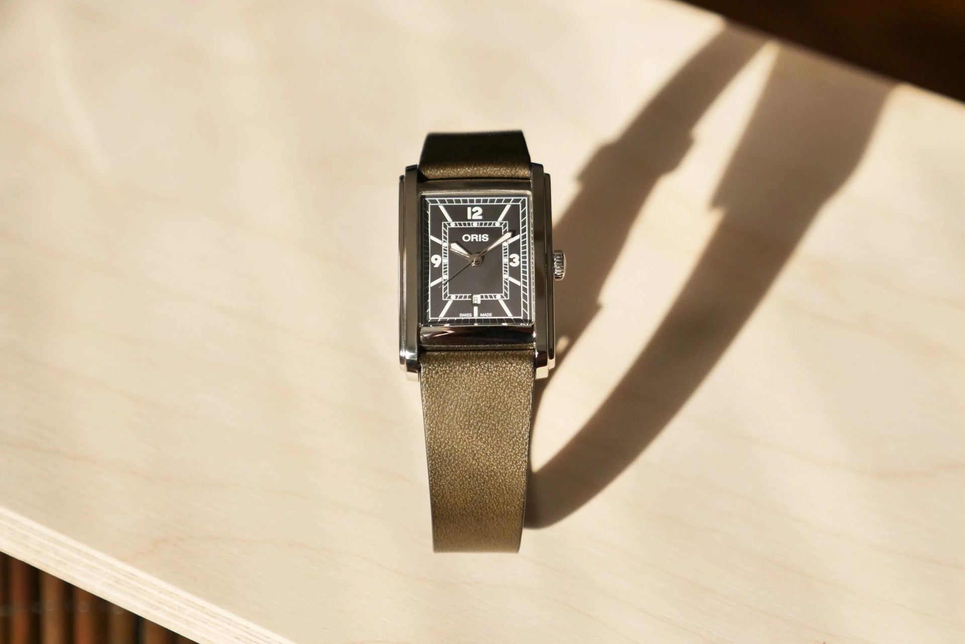 oris rectangular watch on table