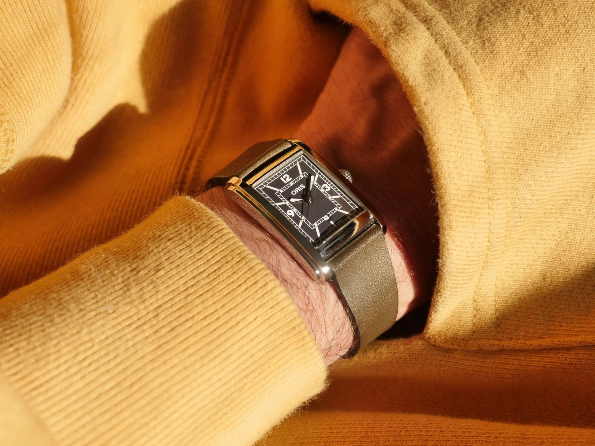 man wearing the oris rectangular watch