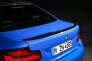 rear bmw m2 cs with a dark studio background