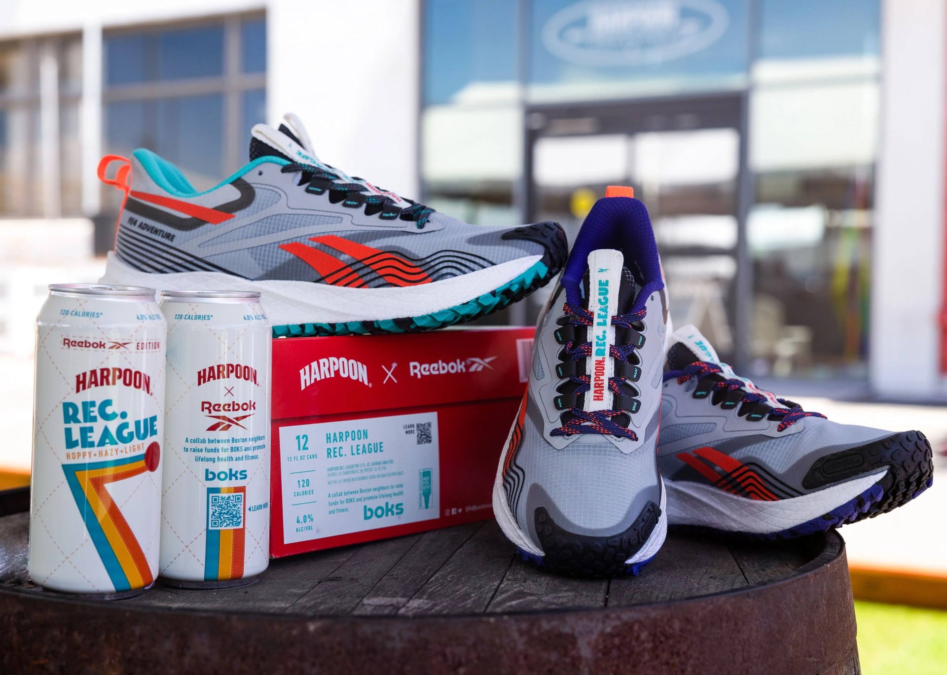 reebok shoes and harpoon  beer sitting on top of a barrel