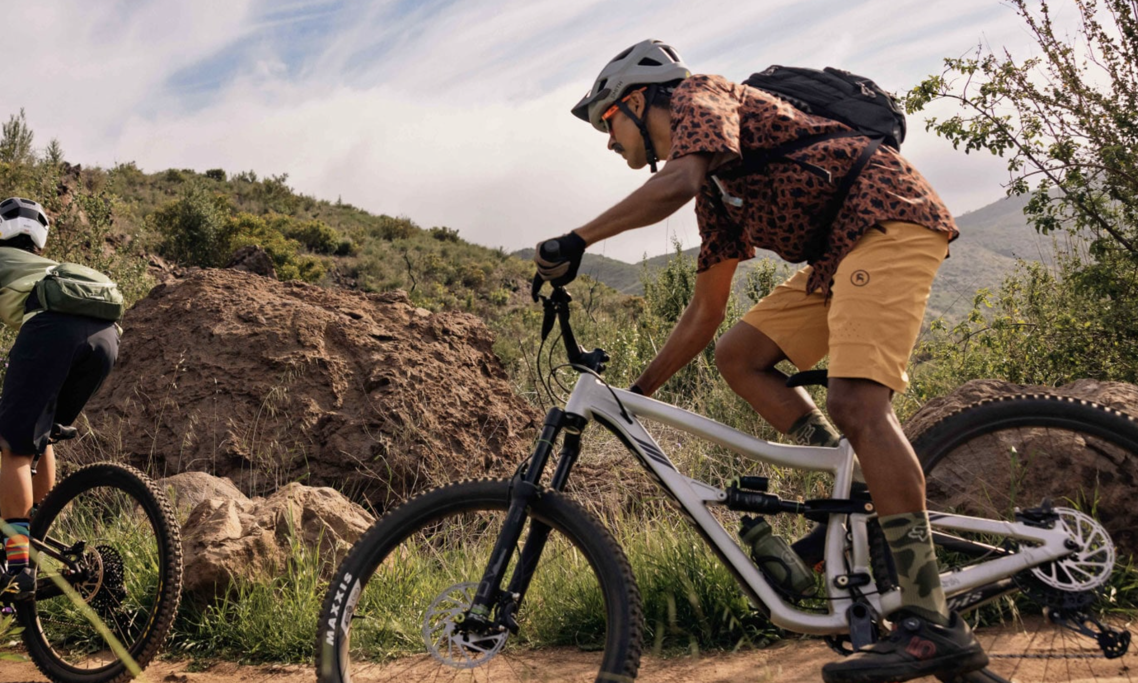 men riding mountain bikes on a trail