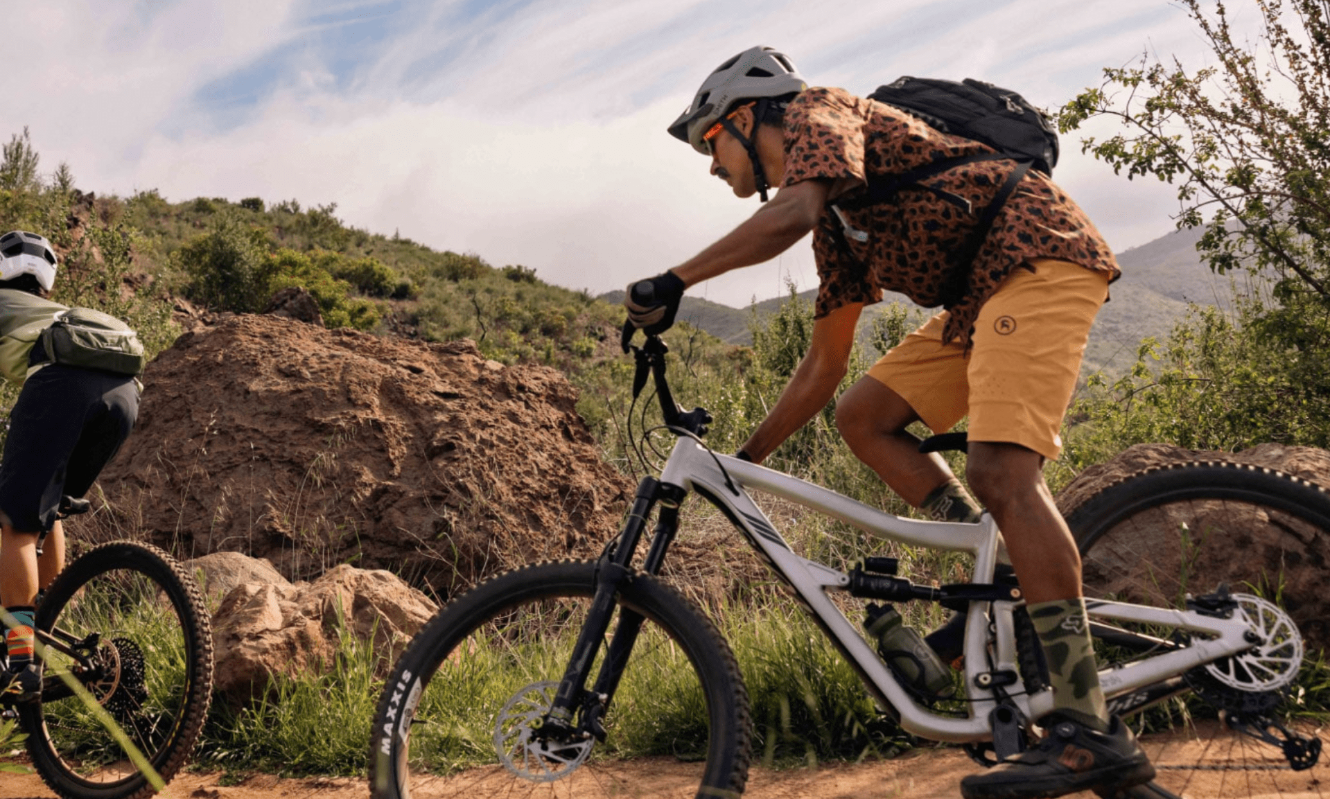 men riding mountain bikes on a trail