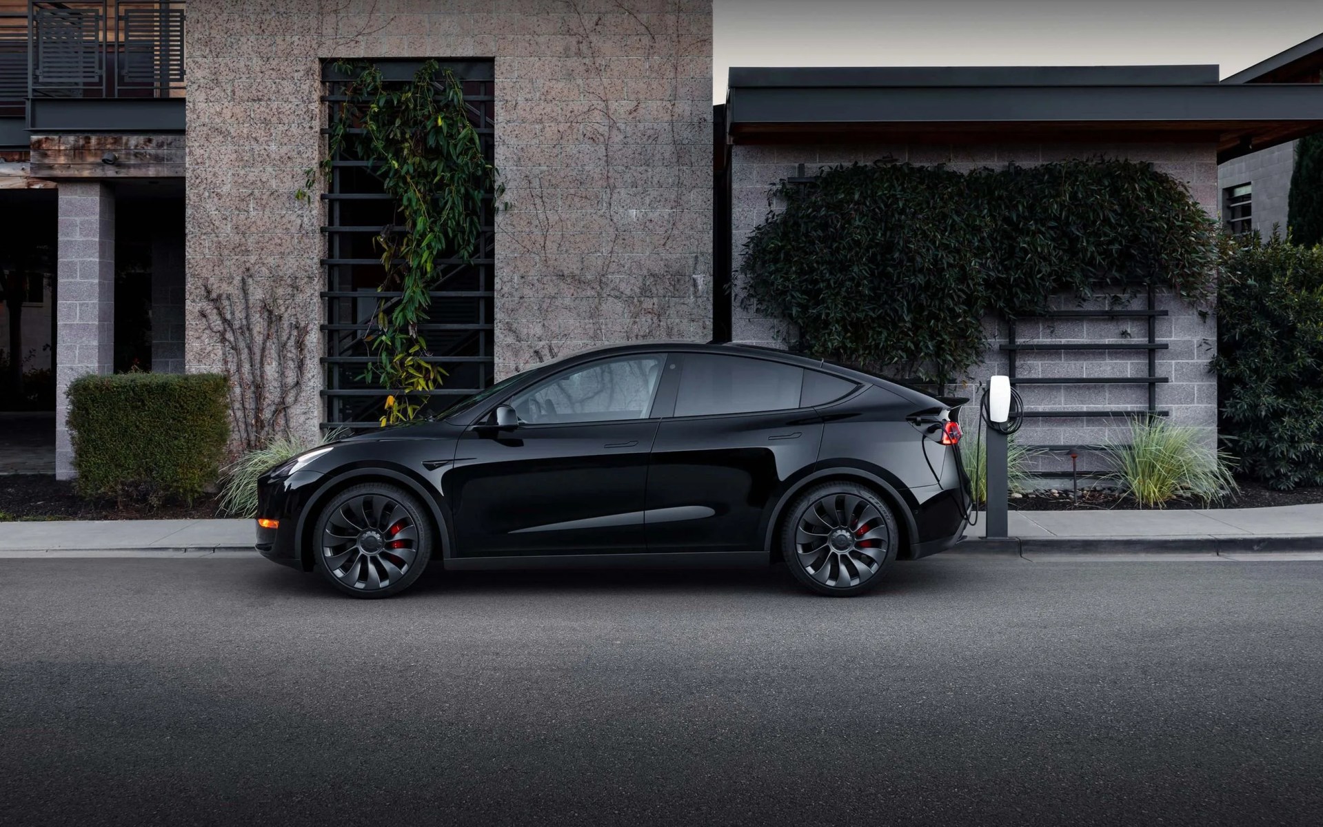black tesla charging at a destination charger