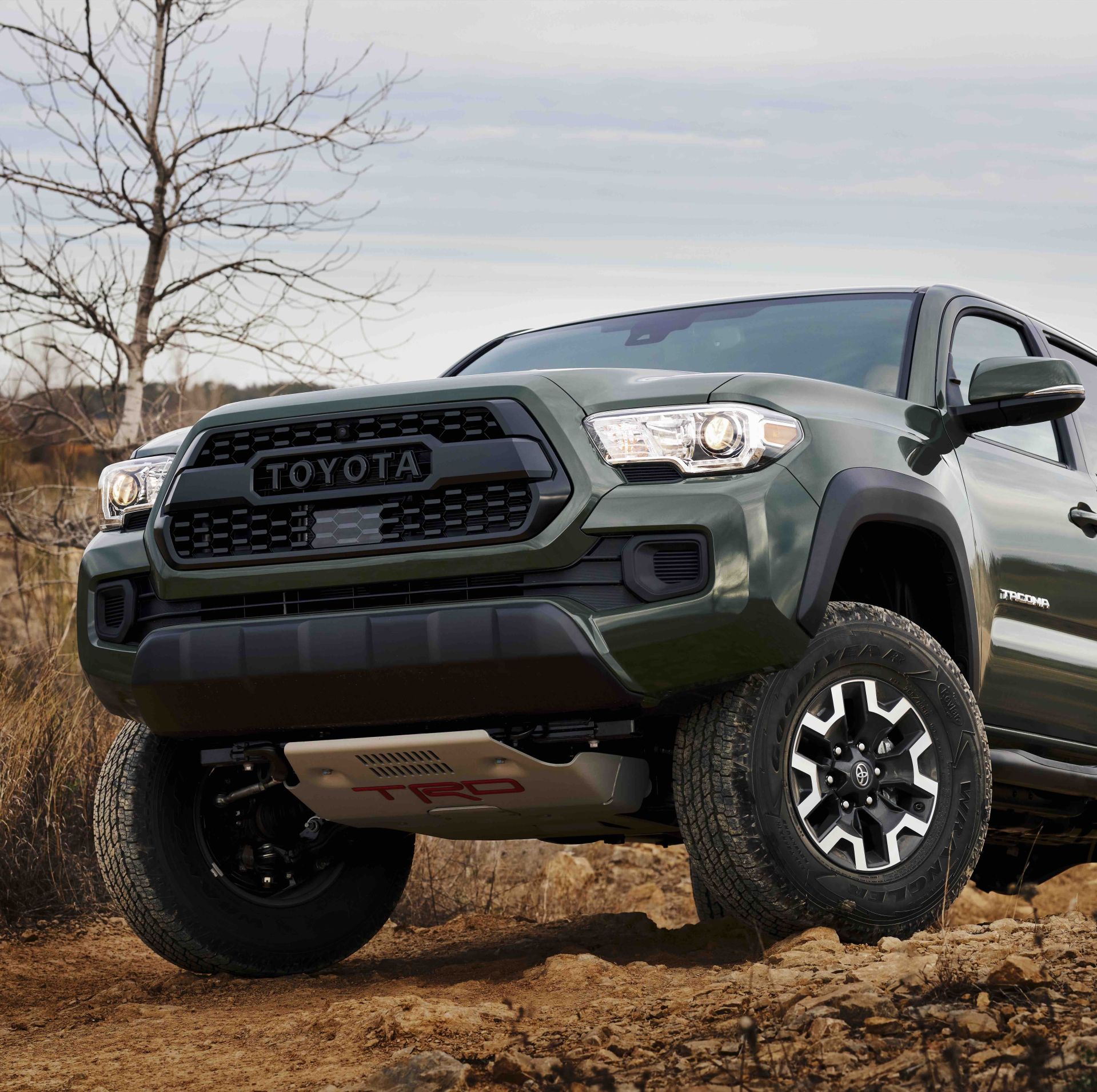toyota tacoma perched on a rocky trail