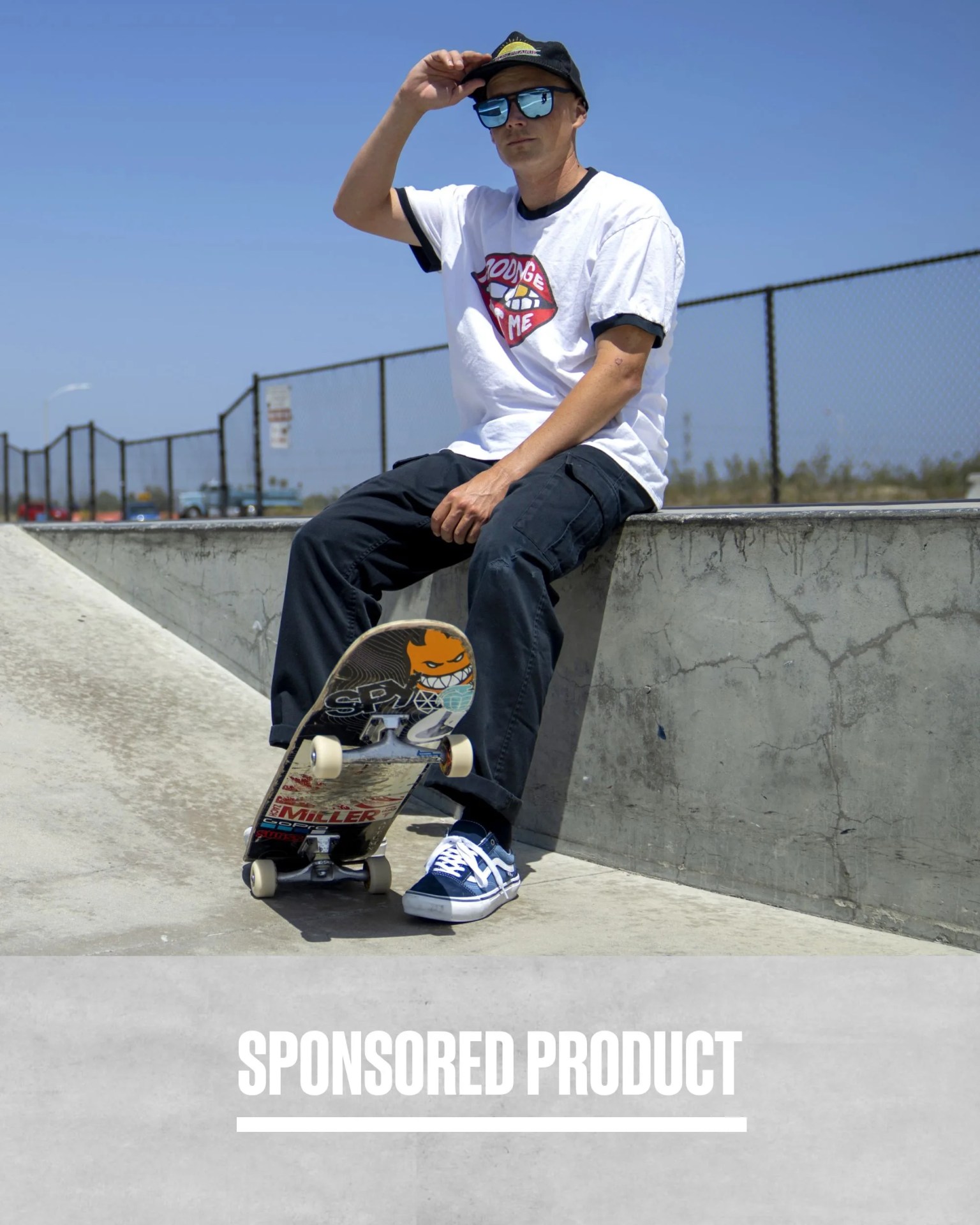 sponsored product man sitting down with feet propped on skateboard wearing spy sunglasses
