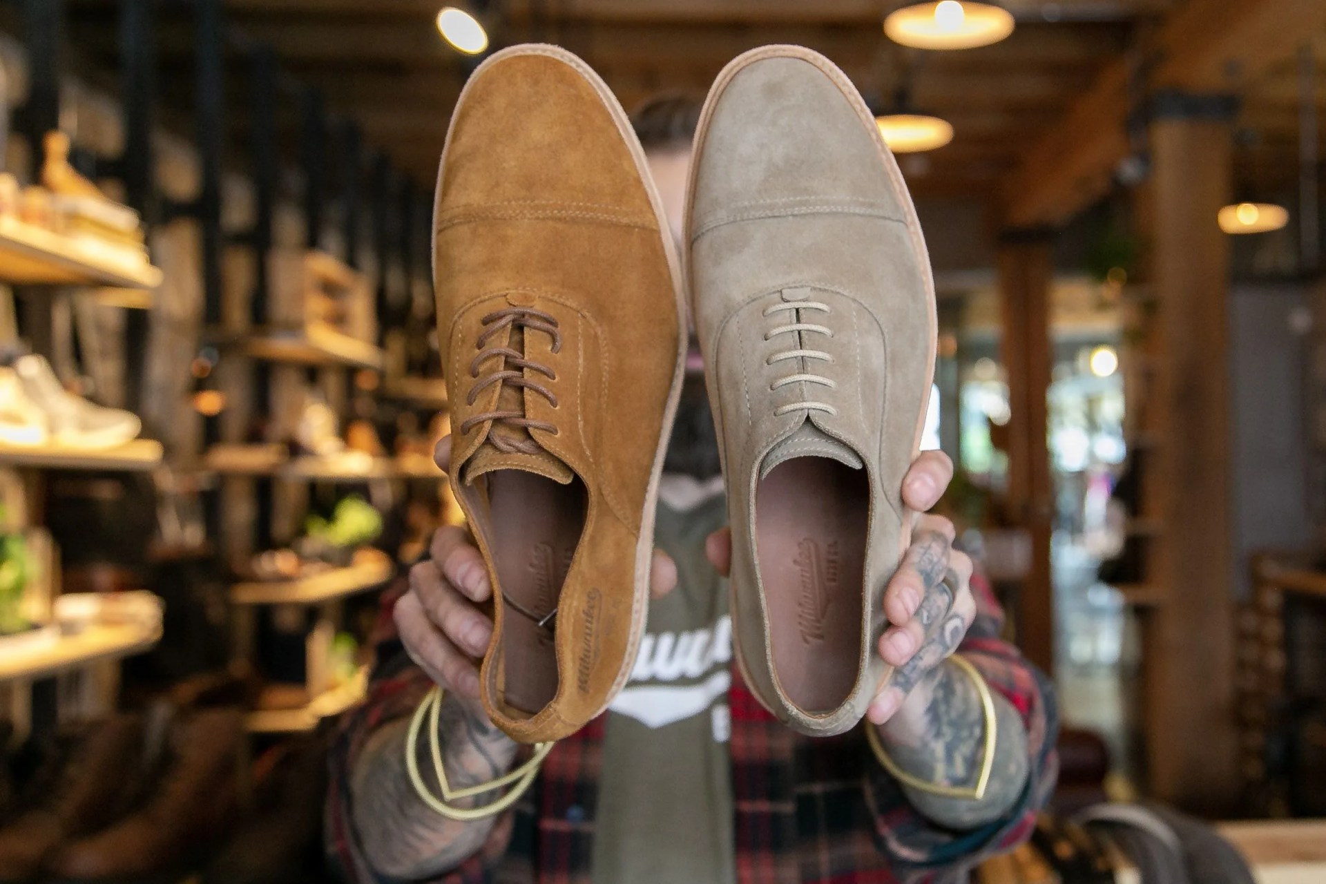 man holding up wdm footwear