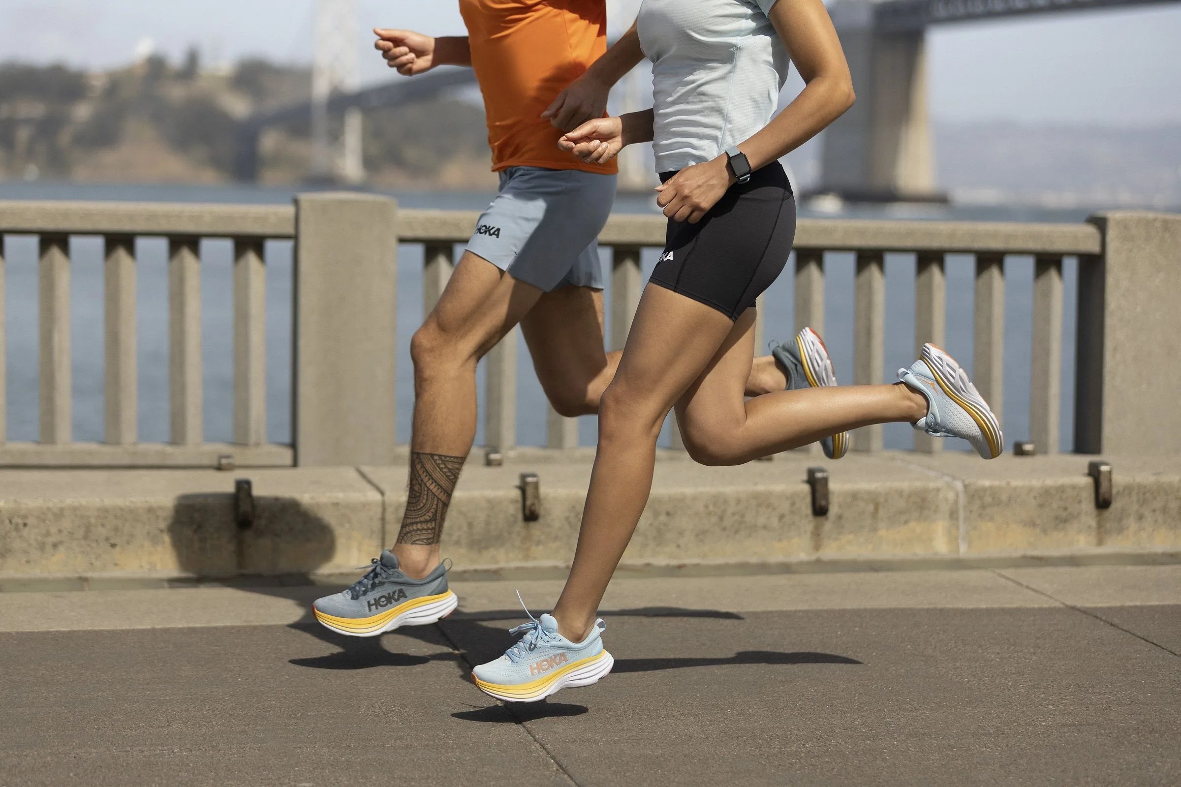 man and woman running in hoka bondi 8 shoes
